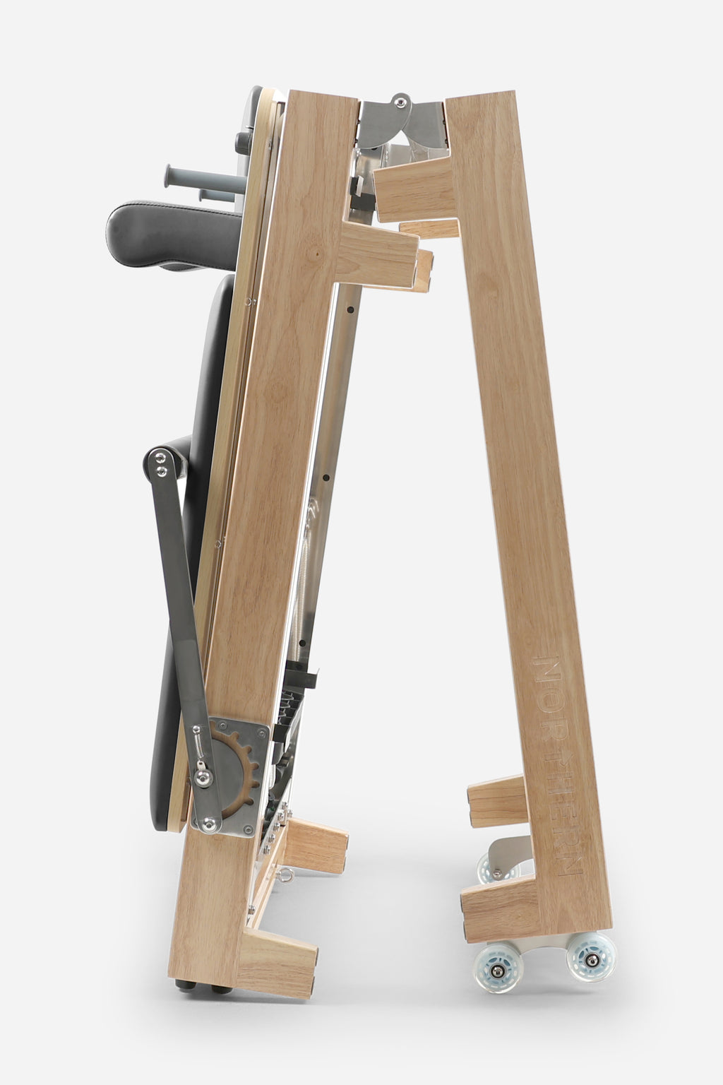 Northern Folding Reformer Bed Black side view showing folding rubberwood frame and transport wheels