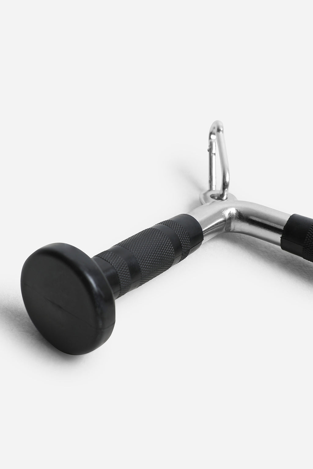 Close-up of textured rubber grip and flared end caps on chrome V-bar attachment