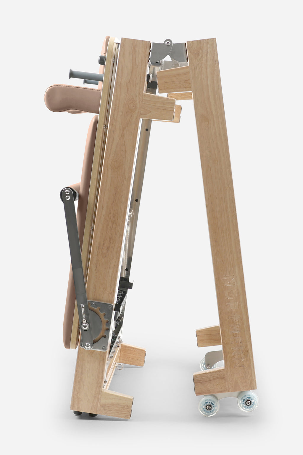 Northern Folding Reformer Bed side view showing folding rubberwood frame and transport wheels