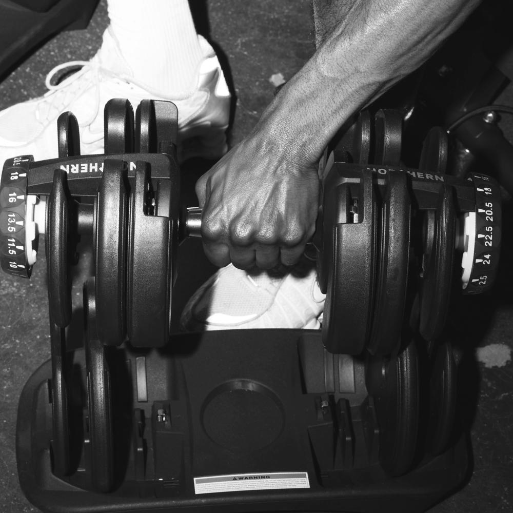 Changing weights in Northern Adjustable Dumbbell from the tray