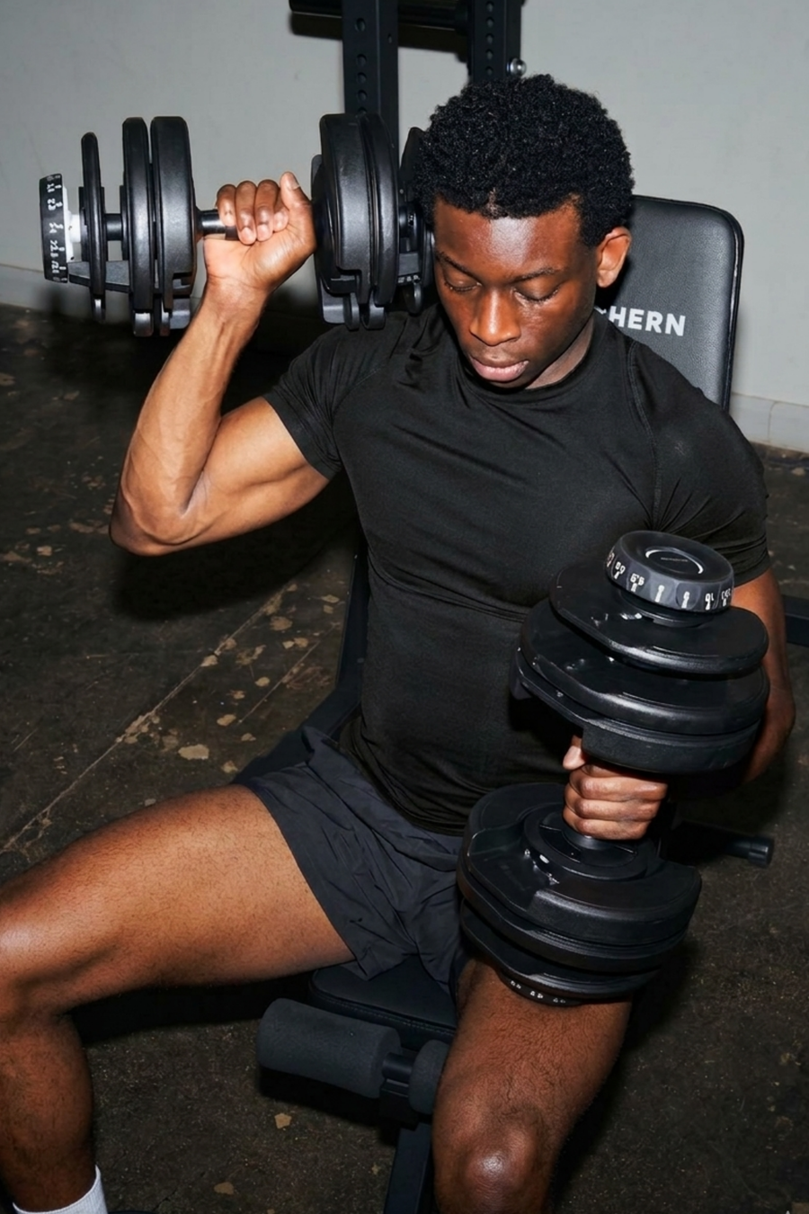 Man using Northern Adjustable Dumbbells for dumbbell tricep extension workout
