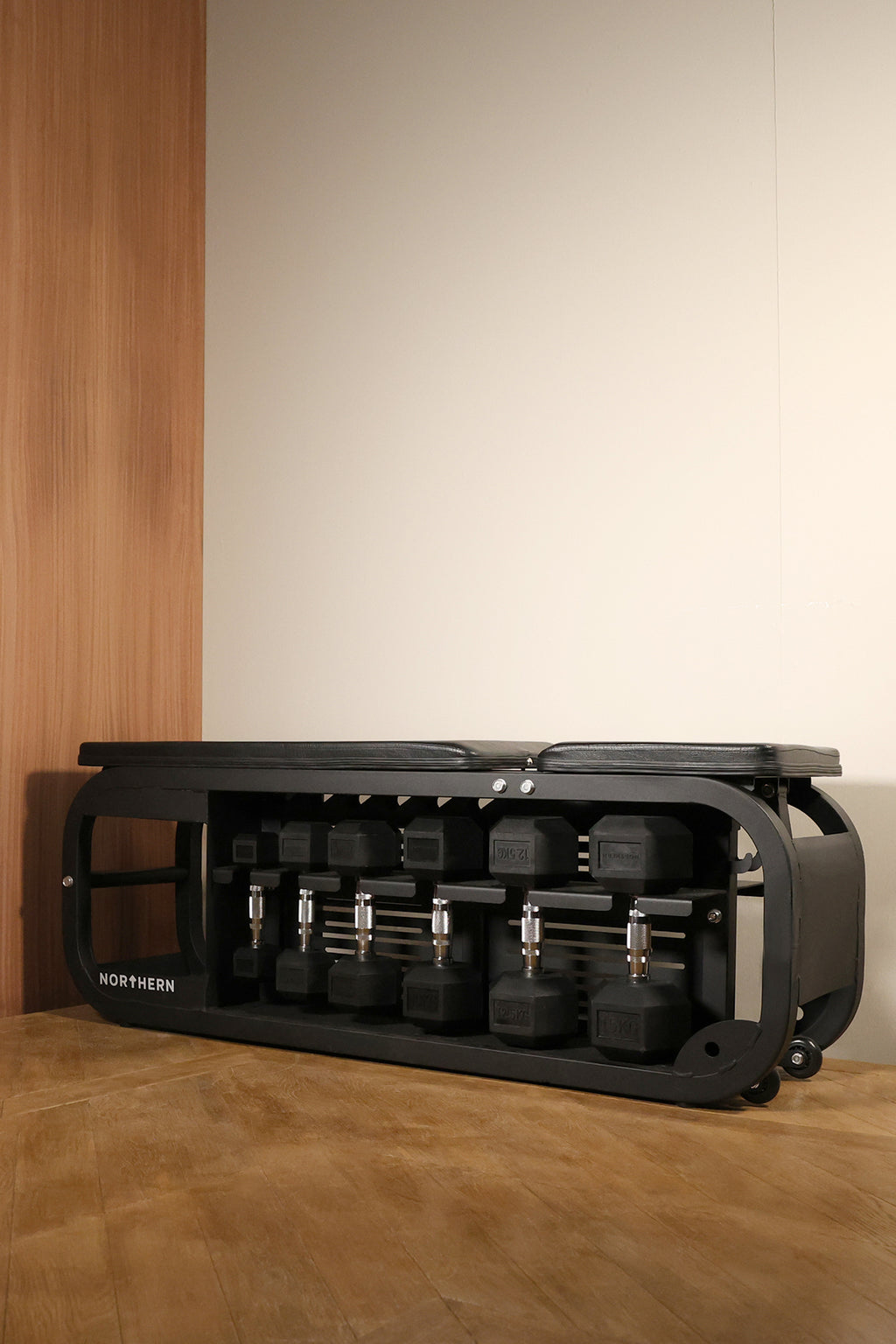 Lifestyle image of adjustable Storage Bench with hex dumbbells set
