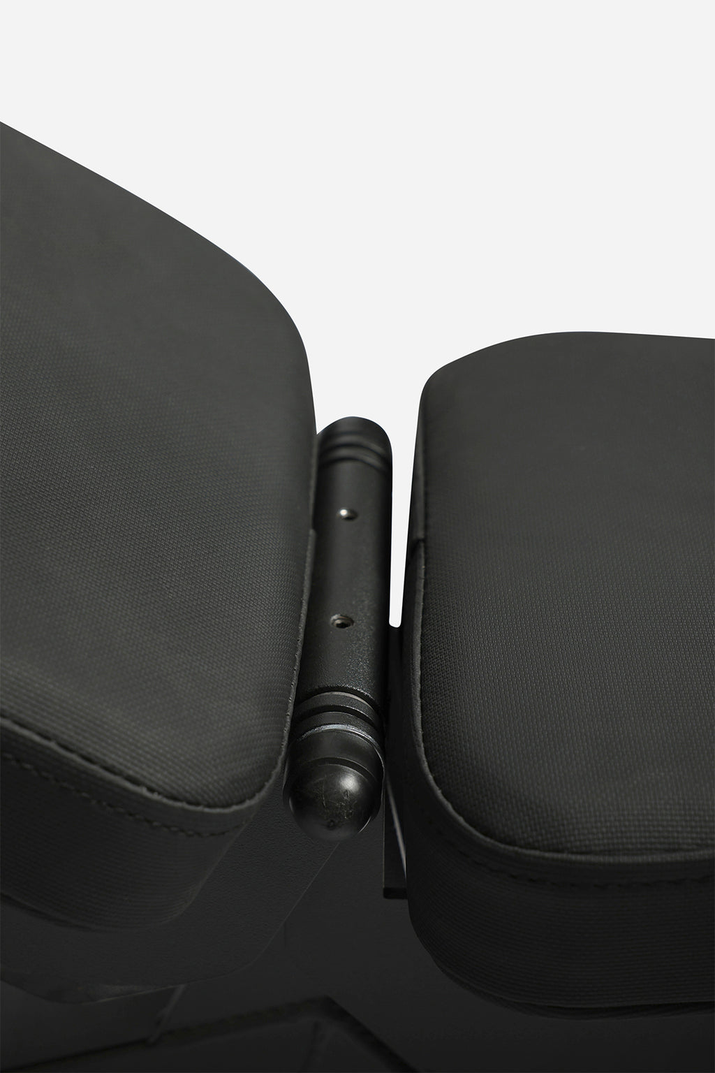 Close-up of weight bench mechanism for flat, incline, and upright backrest settings