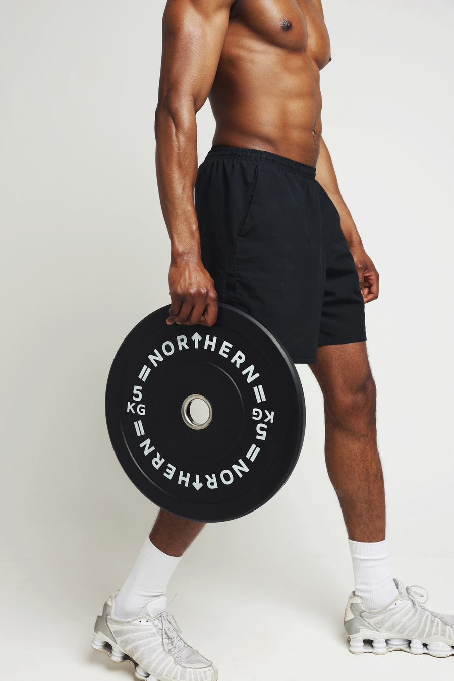 Athlete holding Northern Bumper Plates after a strength training session