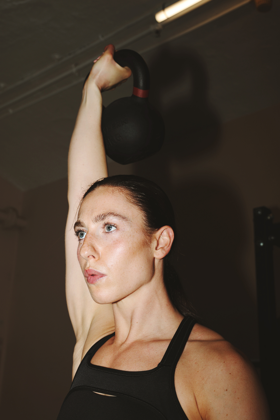 Woman athlete performing overhead workout using Northern Kettlebell Weight