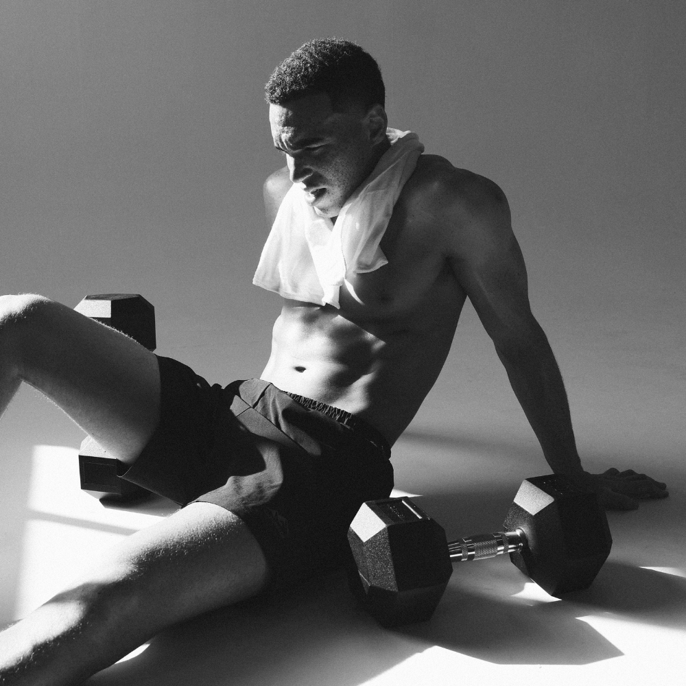 Resting after a functional strength training using rubber hex dumbbells