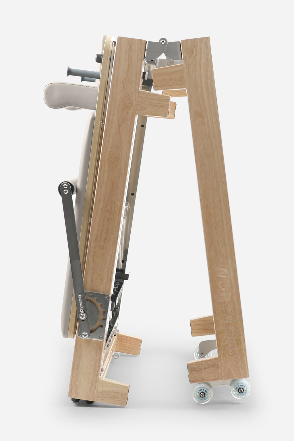 Northern Folding Reformer Bed side view showing folding rubberwood frame and transport wheels