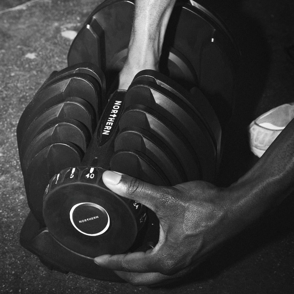 Twisting the dial system to change weight in a adjustable dumbbell