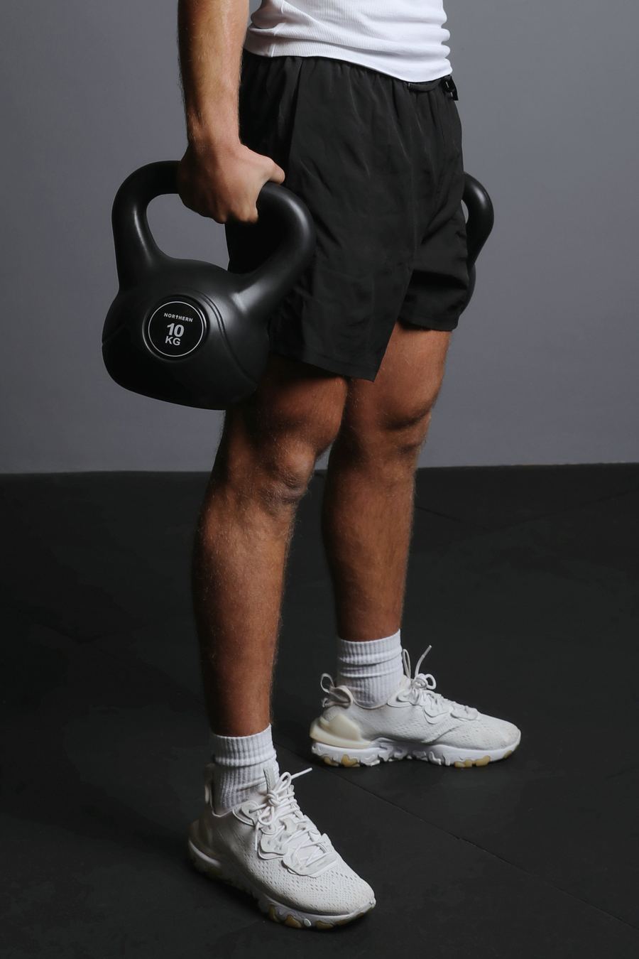 Holding vinyl kettlebell pair with ergonomic grip and non slip feature